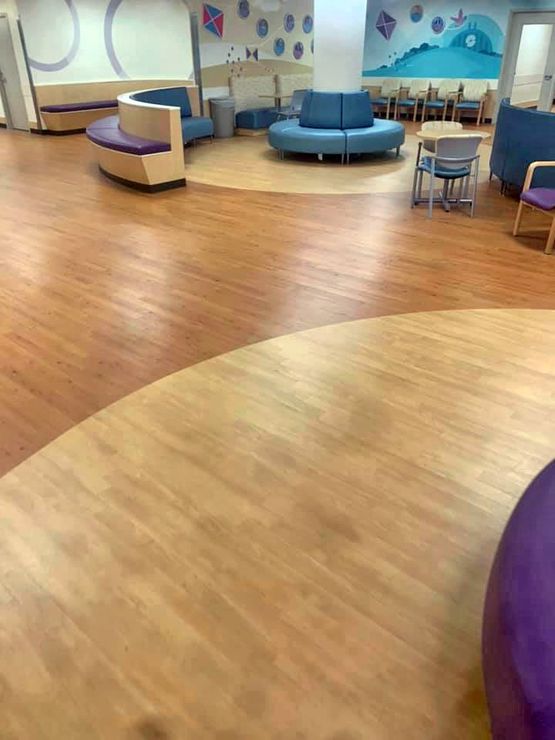 A complex laminate floor installation in a hospital waiting area