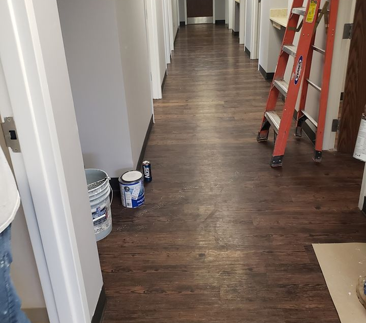 Engineered hardwood is just about finished being installed in this office hallway.