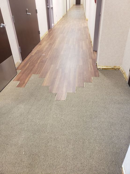Progress photo of luxury vinyl plank flooring installation.