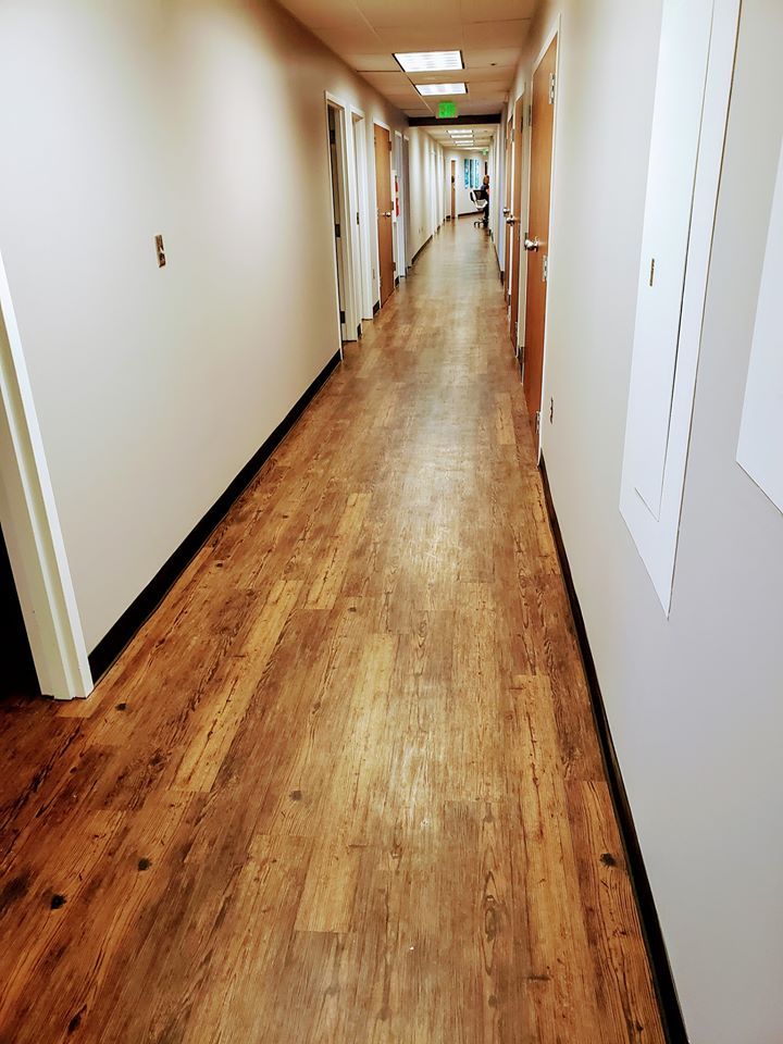 This office hallway looks great decked out with hardwood flooring.