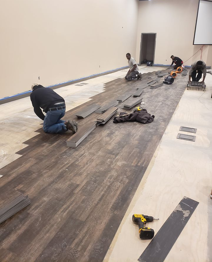Some of our contractors installing vinyl flooring.