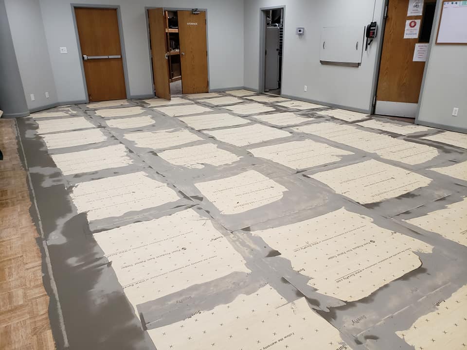 Subfloor is being prepared for new floor installation in this floor replacement project.