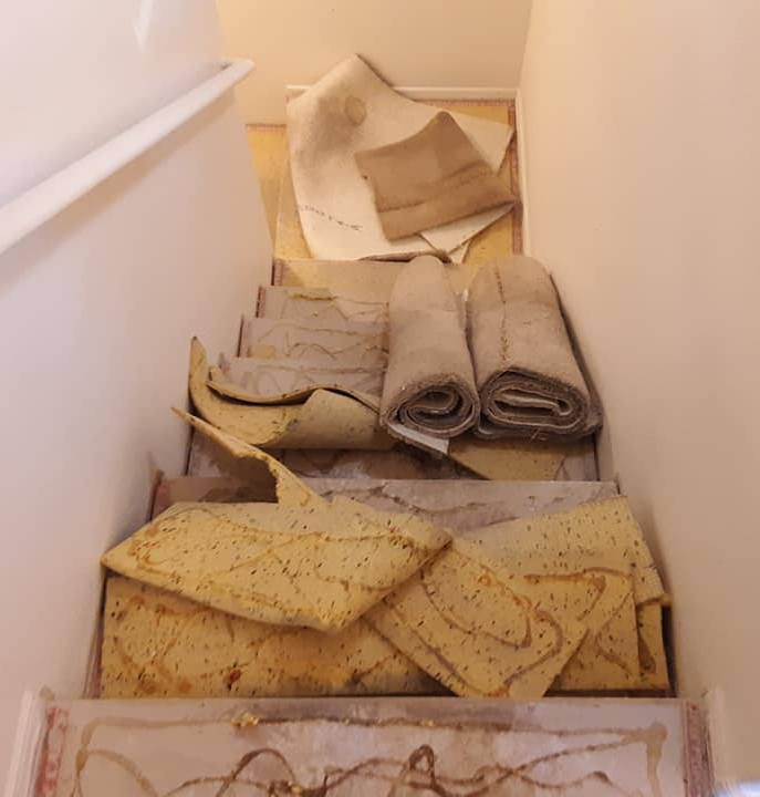 Carpet removal on a set of stairs, getting ready for floor replacement service.