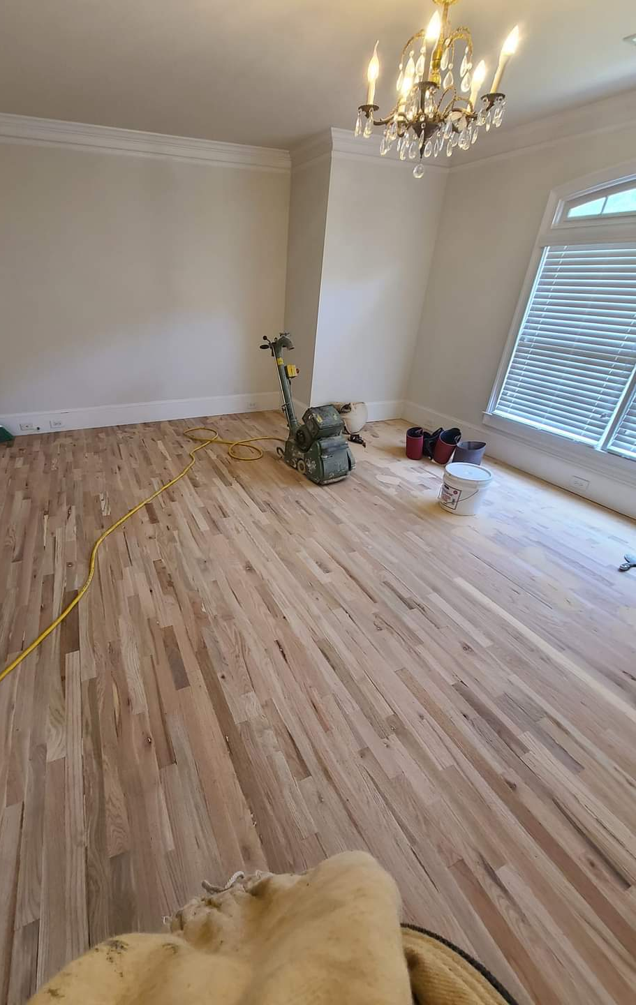 Polishing and sanding this freshly installed solid hard wood flooring.