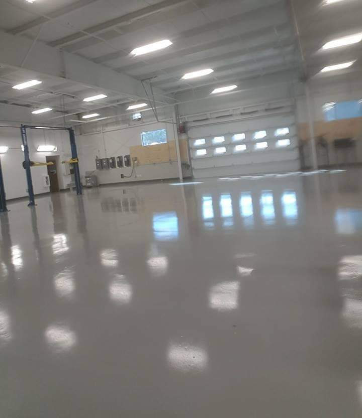 Large auto bays are pictured in this garage with epoxy flooring