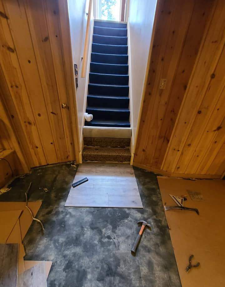 The old flooring must be removed before the carpet can be installed in this basement.