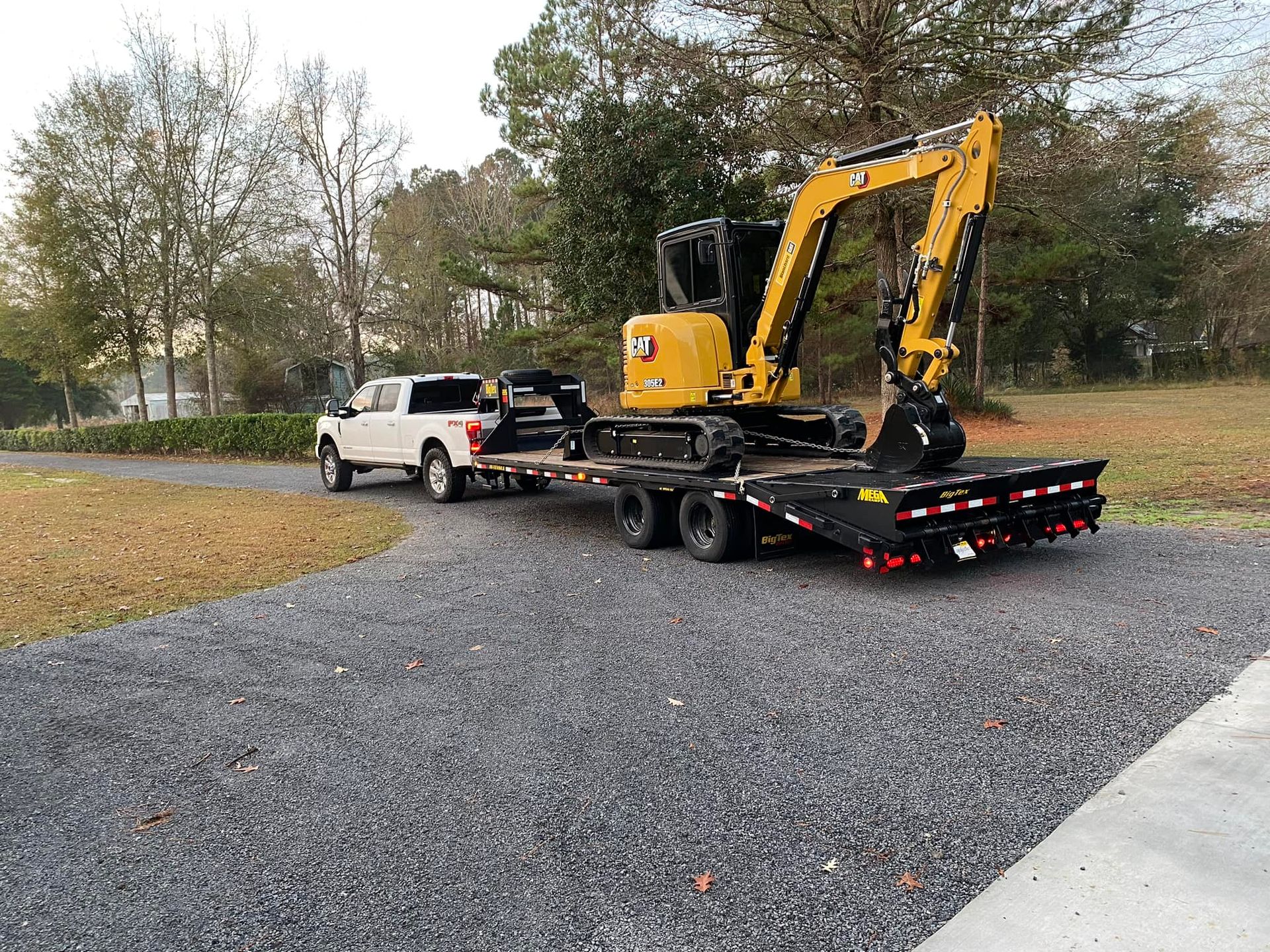 a yellow cat excavator is on a flatbed trailer