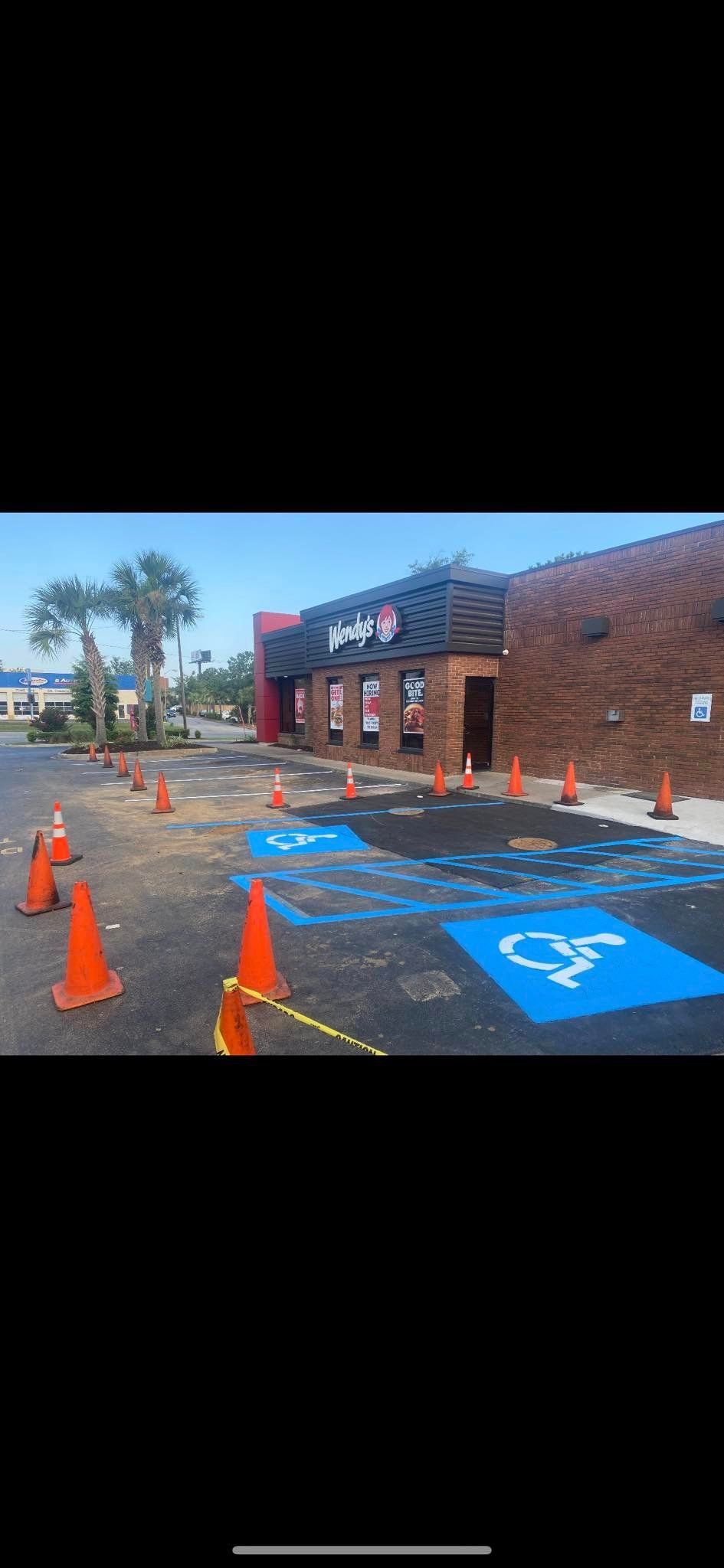 a wendy 's restaurant has a handicapped parking space painted in blue