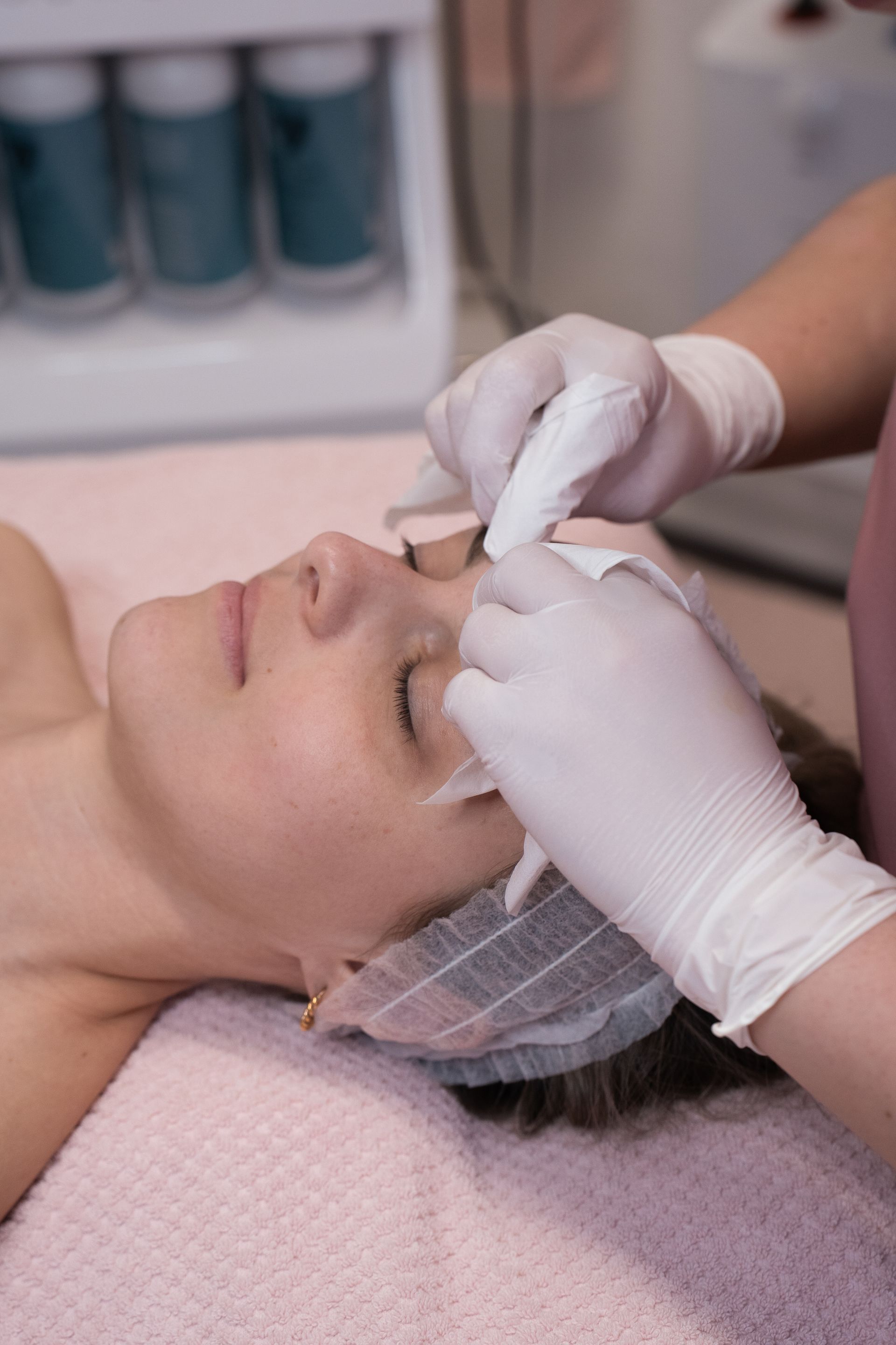 A woman is getting a facial treatment at a beauty salon.