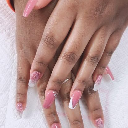 A close up of a woman 's hands with pink and white nails