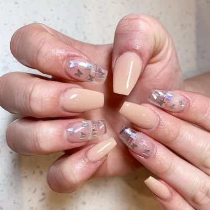 A close up of a person 's nails with butterflies on them.