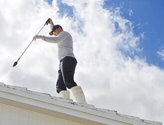 Man cleaning the roof - roofing in Port Richey, FL