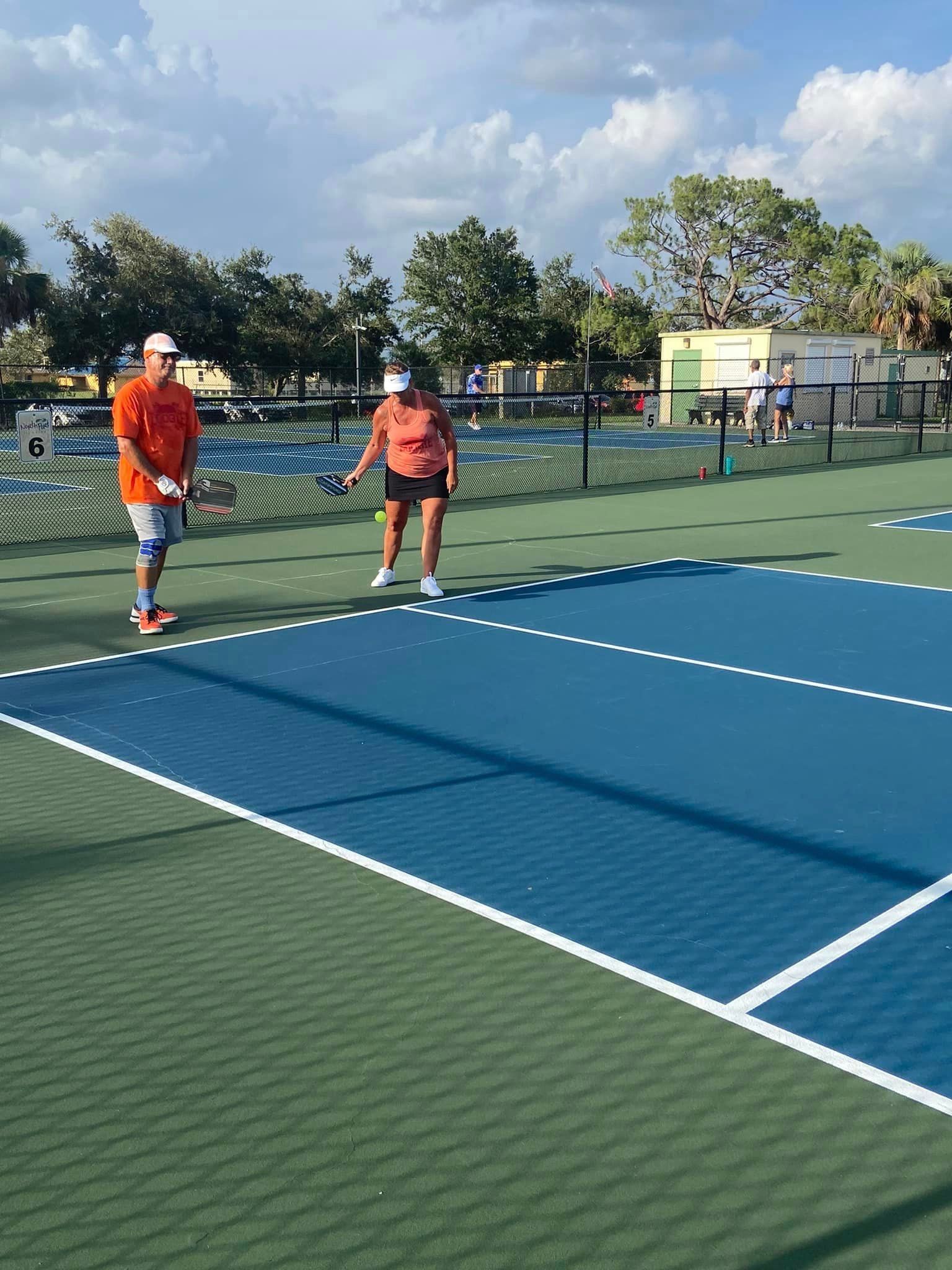 Two Pickleball Players on Court, One Serving — North Port, FL — Team Doogie
