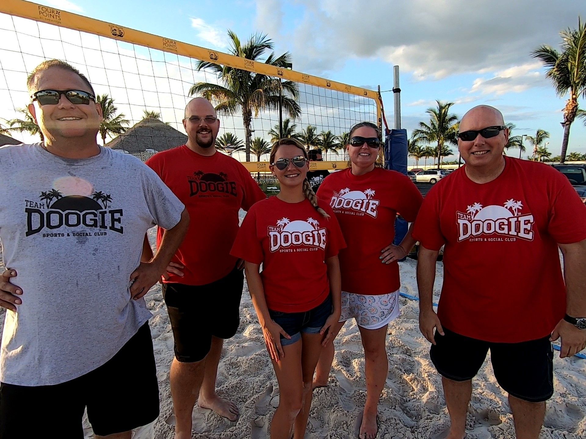 People in Red Shirts Standing on The Sandy Beach — North Port, FL — Team Doogie