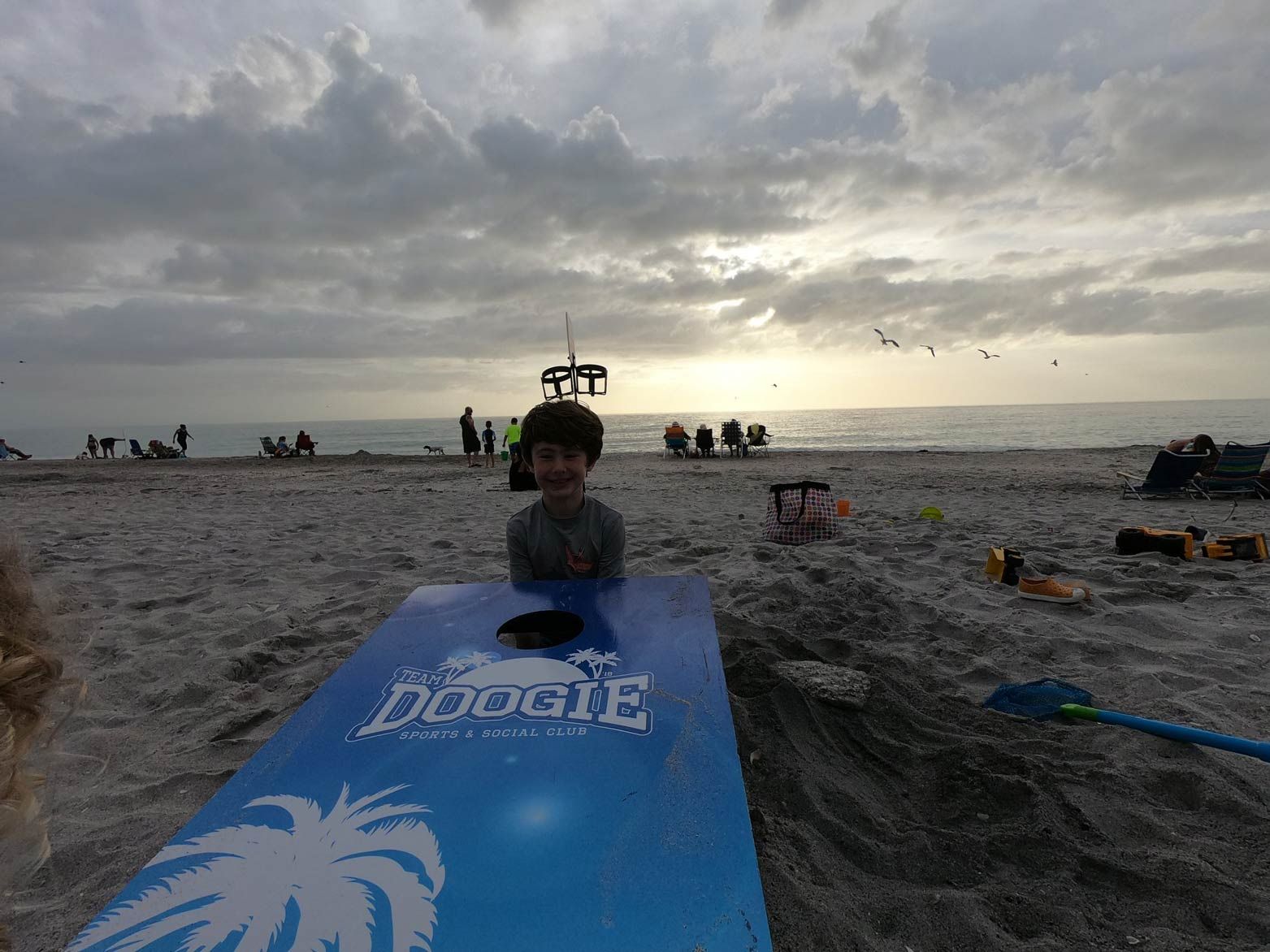 A Boy Behind Cornhole Board — North Port, FL — Team Doogie