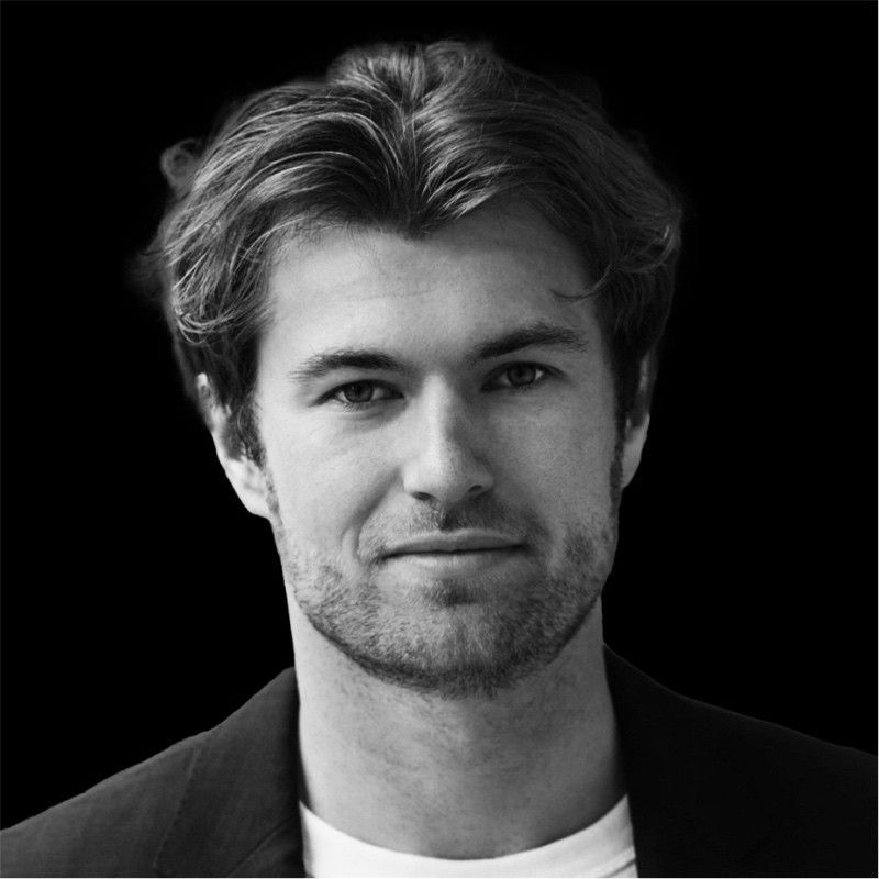 A black and white photo of a man with a beard