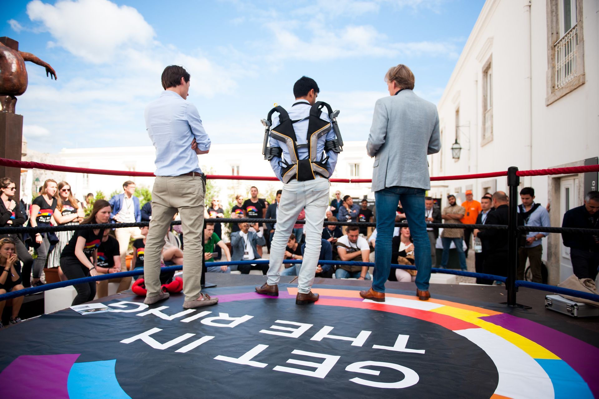 A staircase in a large building with a wooden railing.