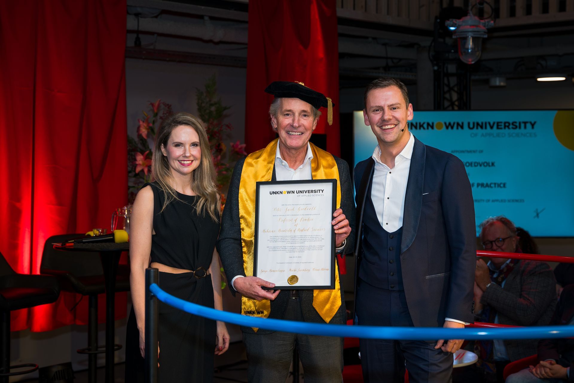 A group of people are standing next to each other holding a certificate.