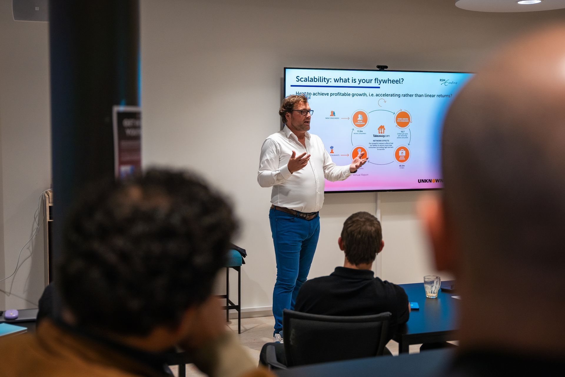 A man is giving a presentation in front of a group of people.
