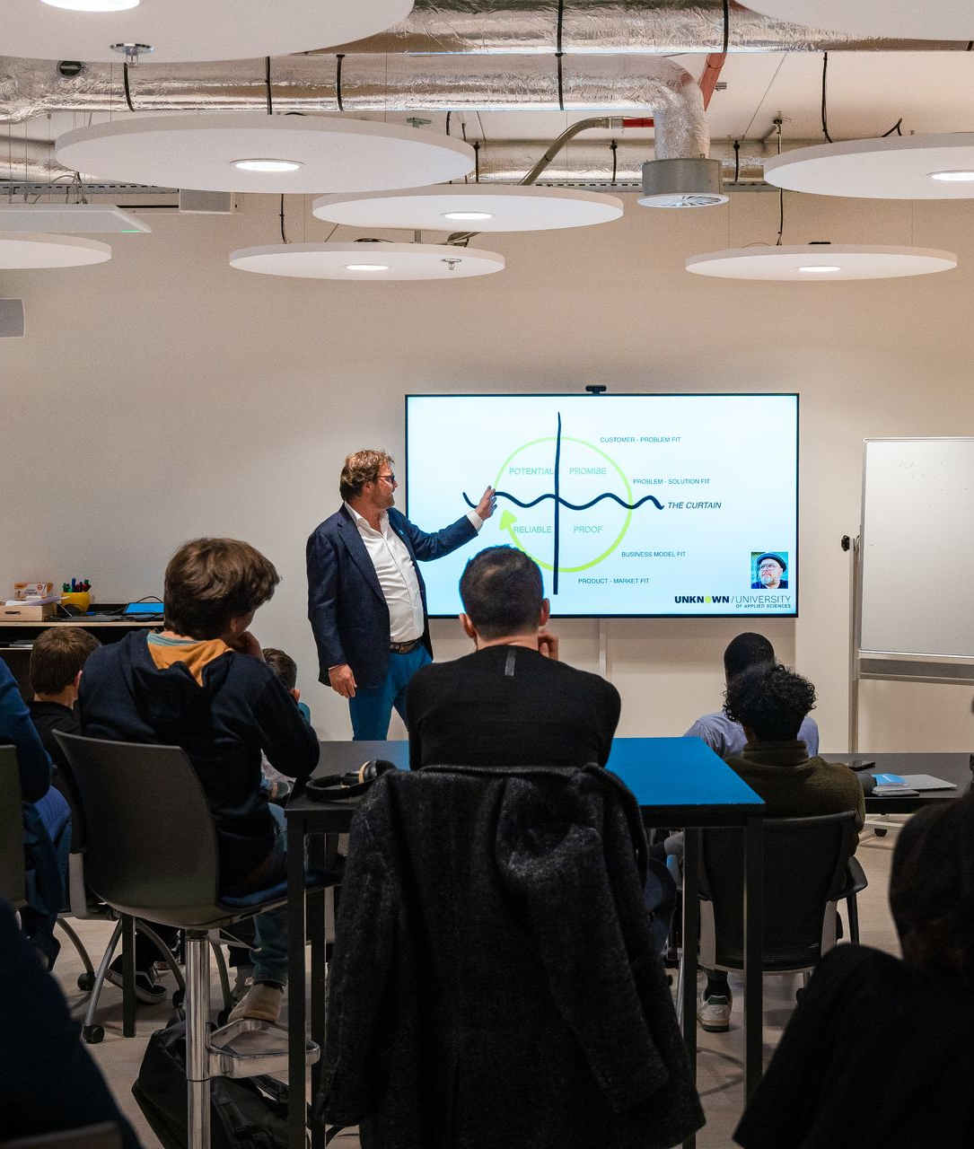 A staircase in a large building with a wooden railing.
