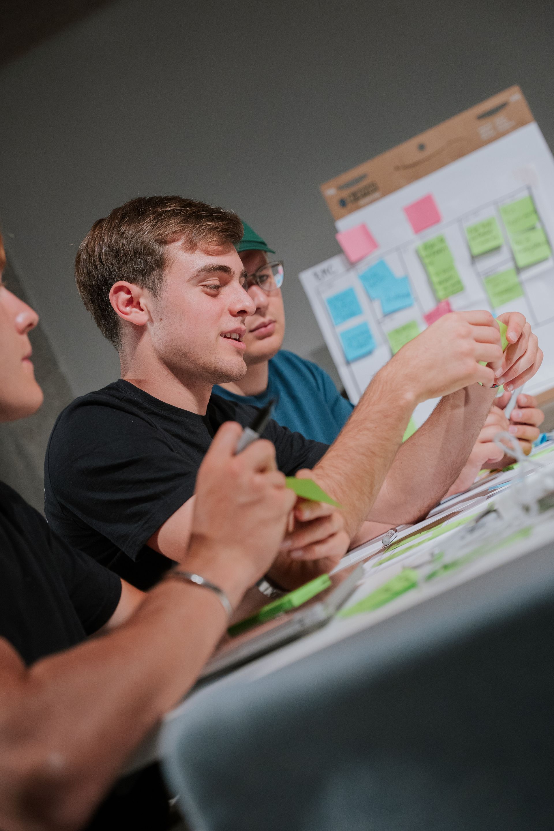 A hallway in a building with stairs and a glass door.