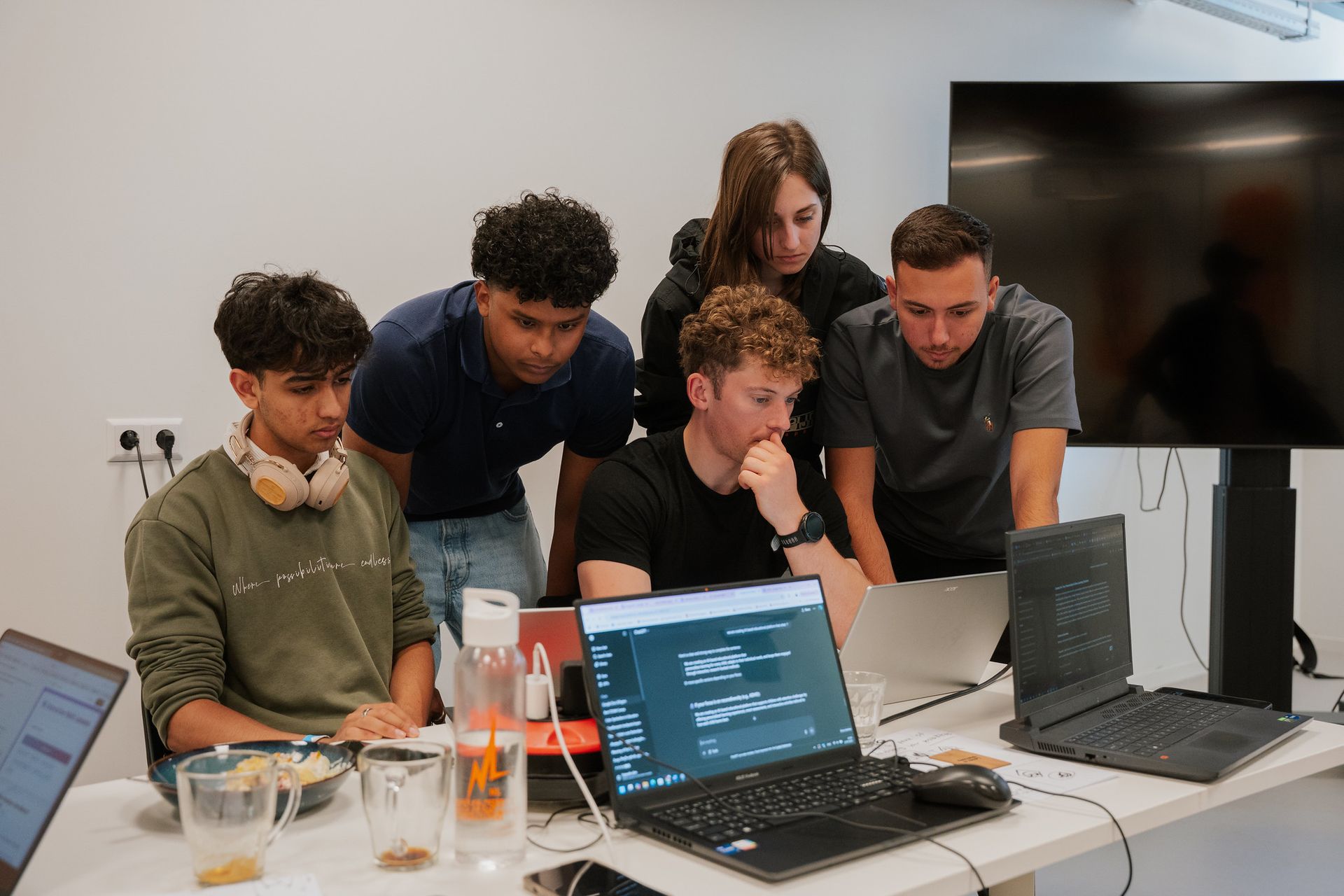 A group of people are sitting around a table in a room.