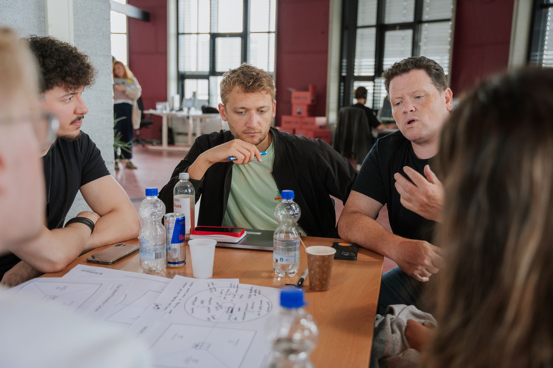 A man and a woman are standing next to each other talking into microphones.