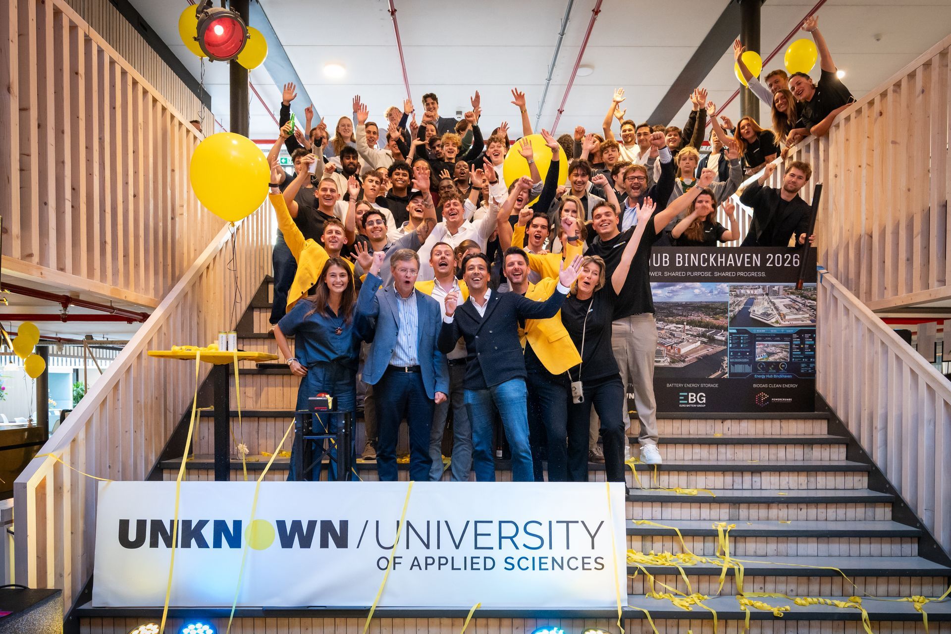 A group of people are sitting on couches in a living room.