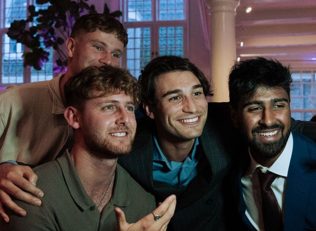A group of young men are posing for a picture together.