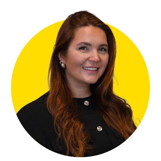 A woman in a black shirt is smiling in a yellow circle