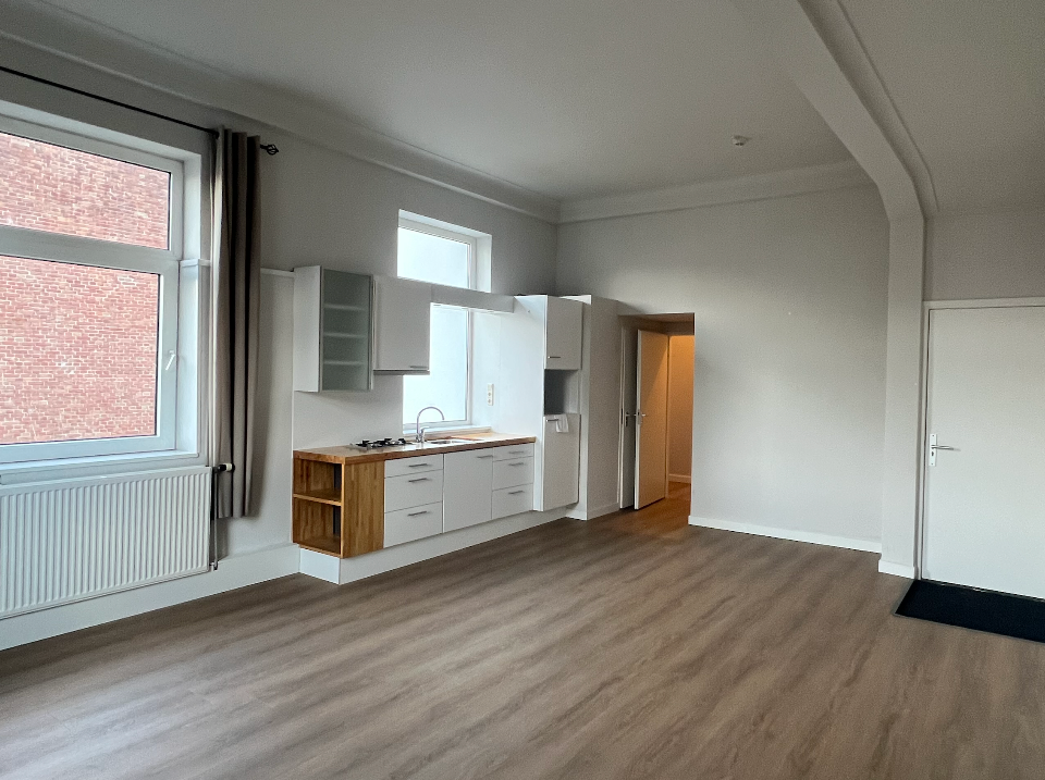 There is a kitchen in the middle of the room.