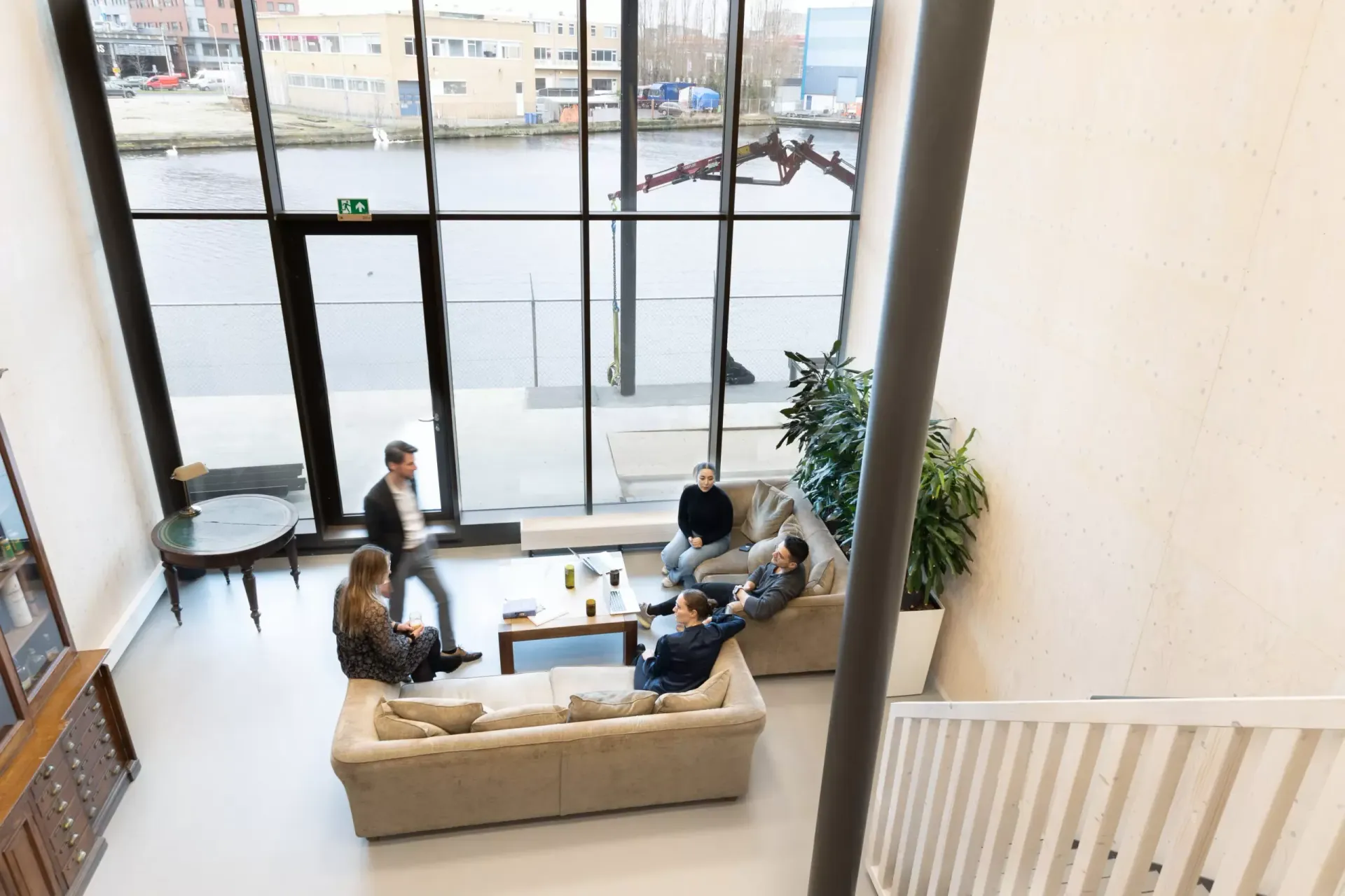 A group of people are sitting on couches in a living room.