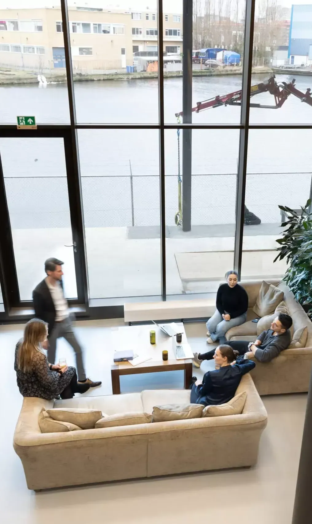 A group of people are sitting on couches in a living room.