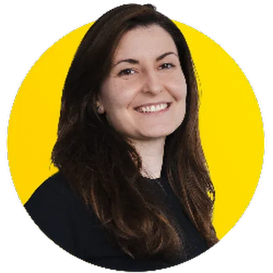 A woman in a black shirt is smiling in a yellow circle