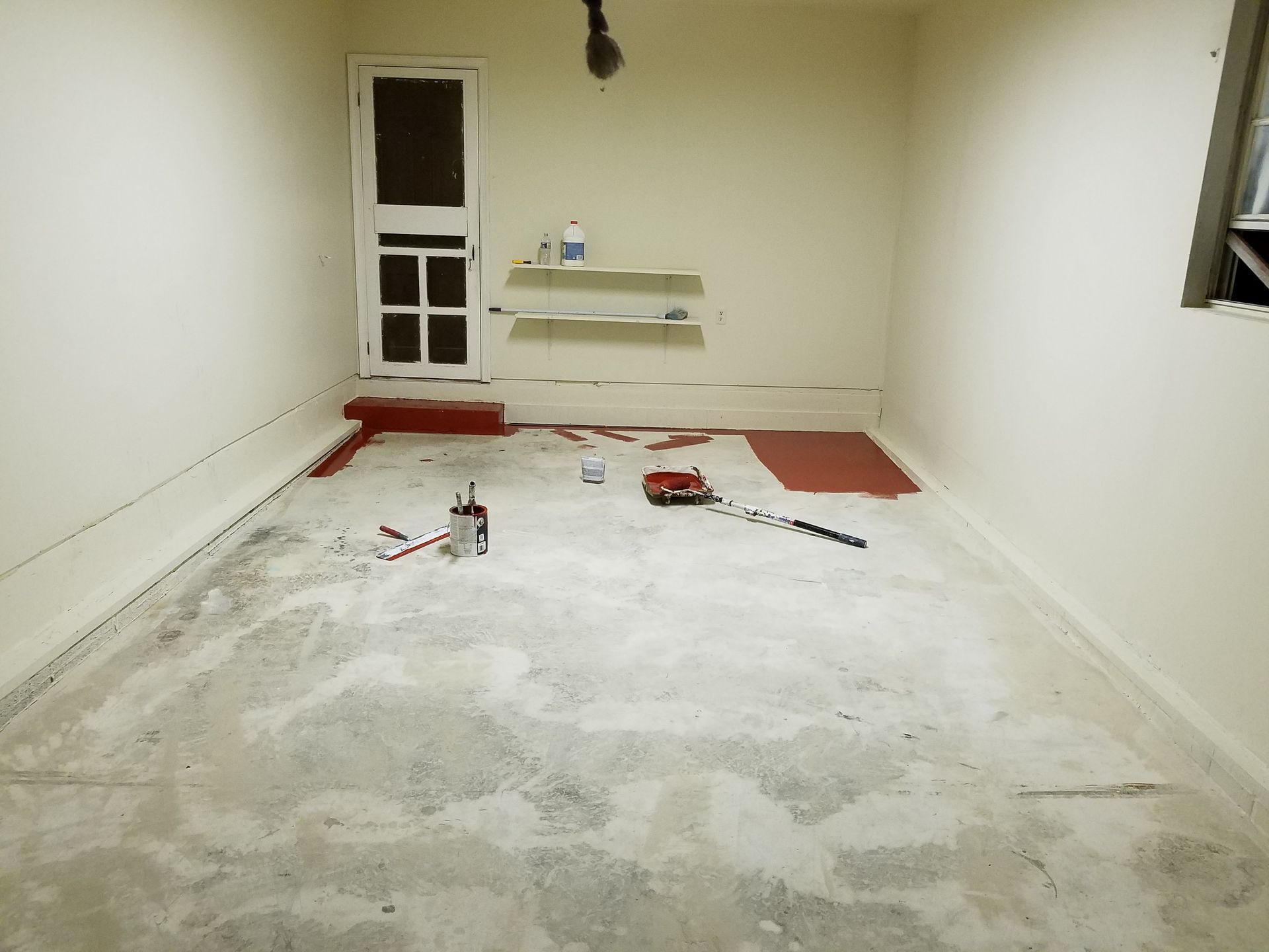 A room with white walls and a red rug on the floor