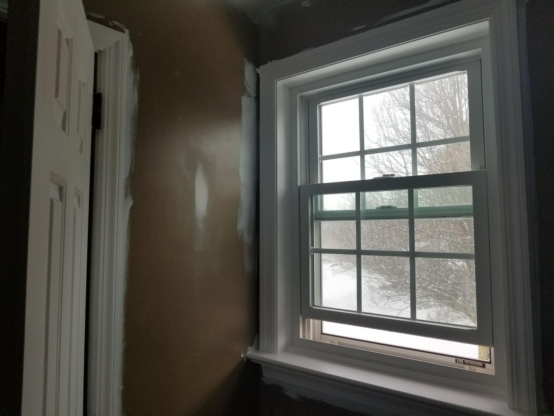 A window in a room with a door in the background