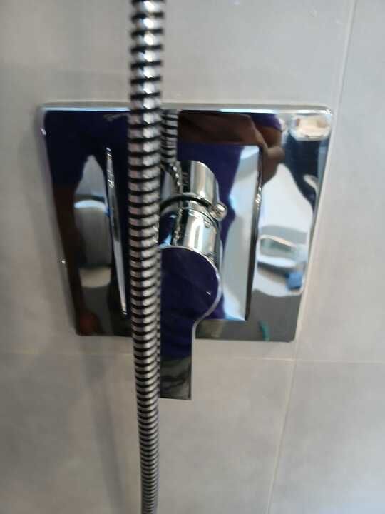 A chrome shower head with a hose attached to it