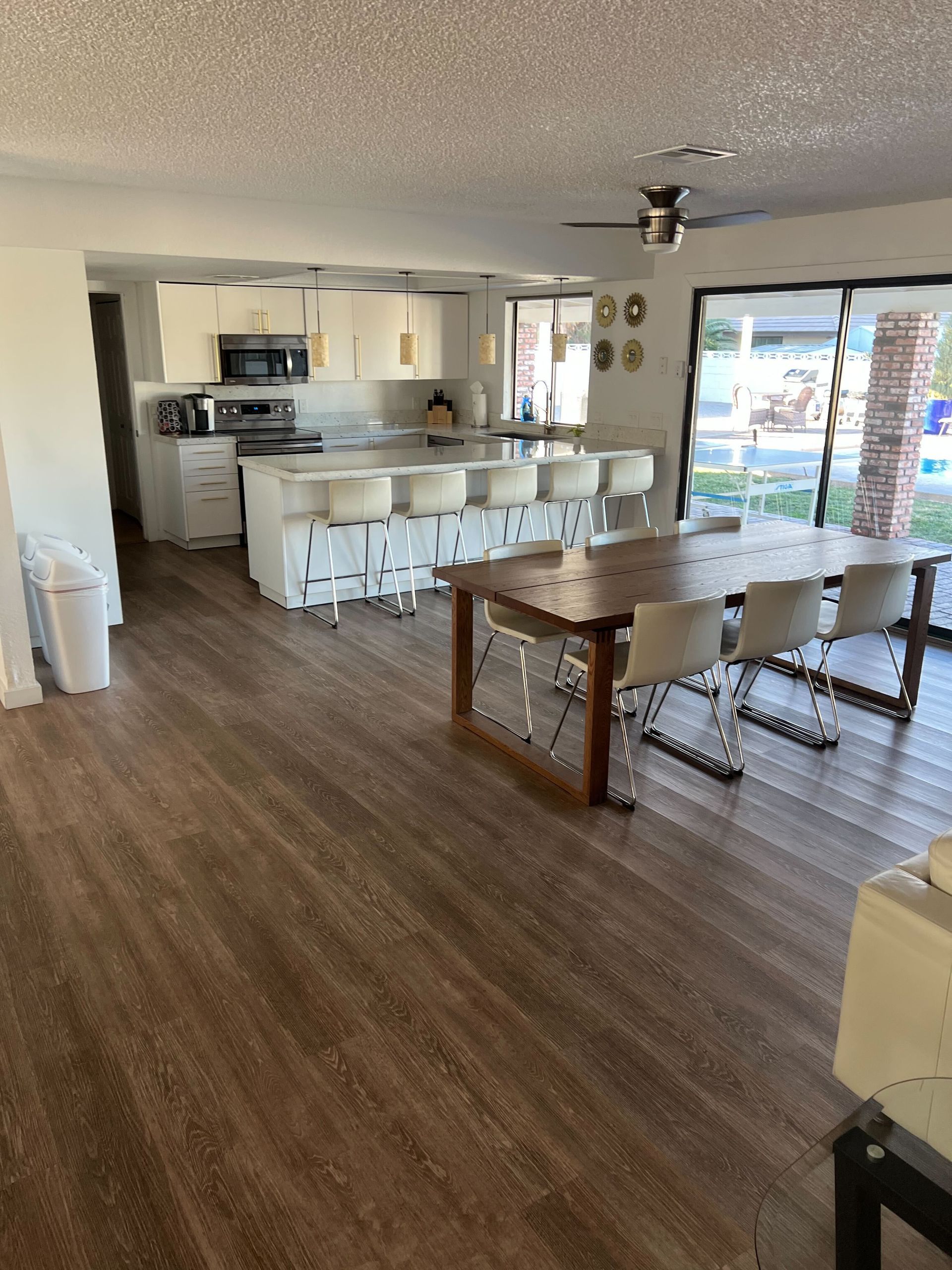 A living room with a table and chairs and a kitchen