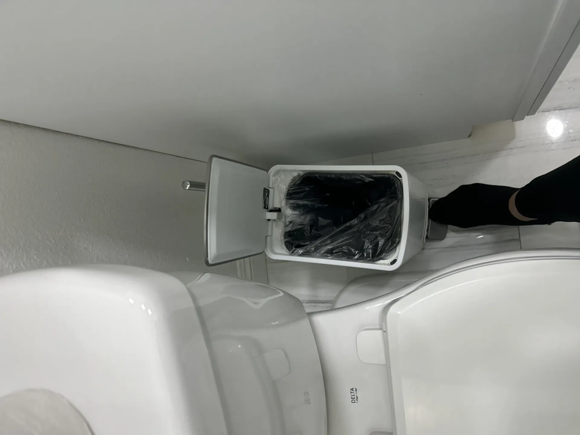 A shiny, disinfected sink with toiletries, hand soap, and fresh essentials neatly arranged.