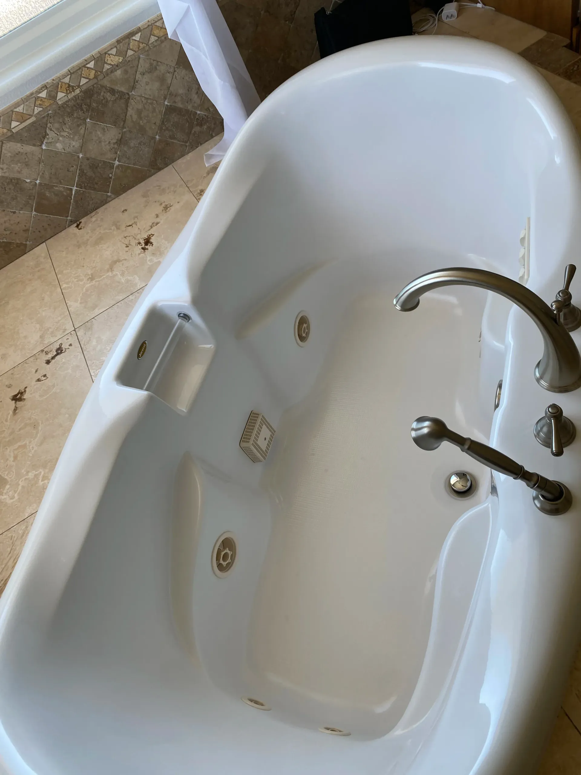 A white bathtub with a faucet in a bathroom.