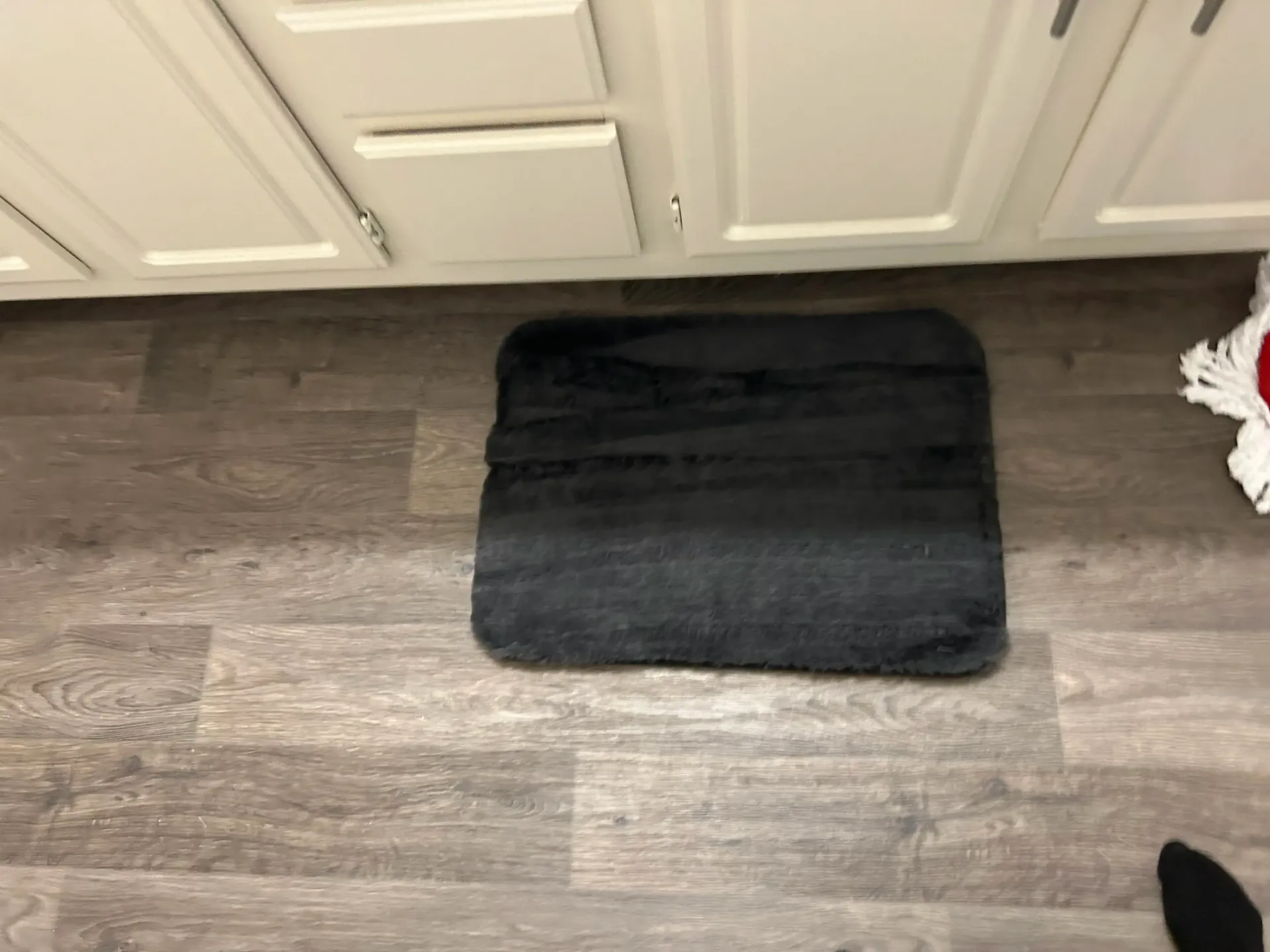 Three suitcases are sitting on the floor in a closet.