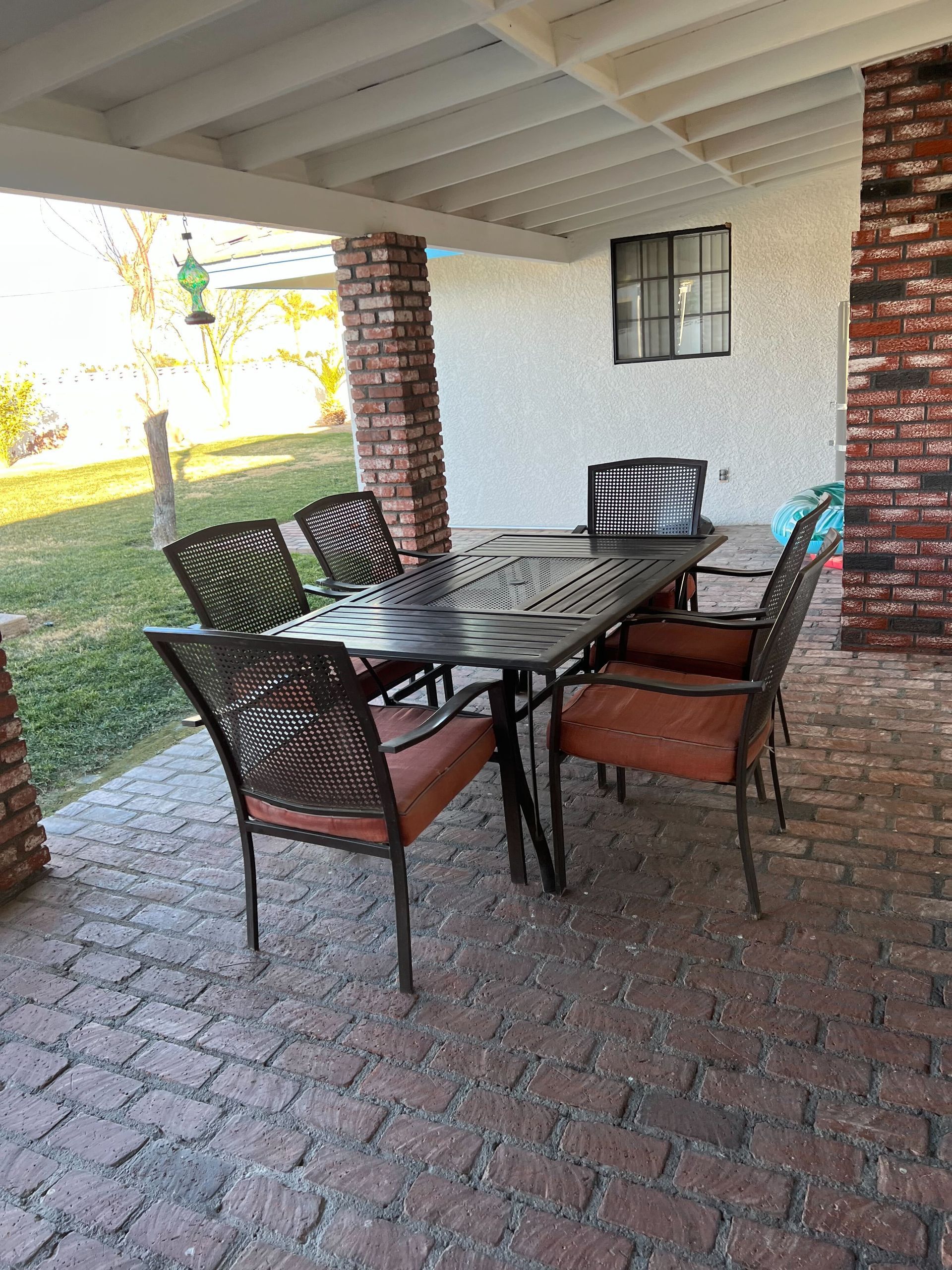 A patio with a table and chairs on it