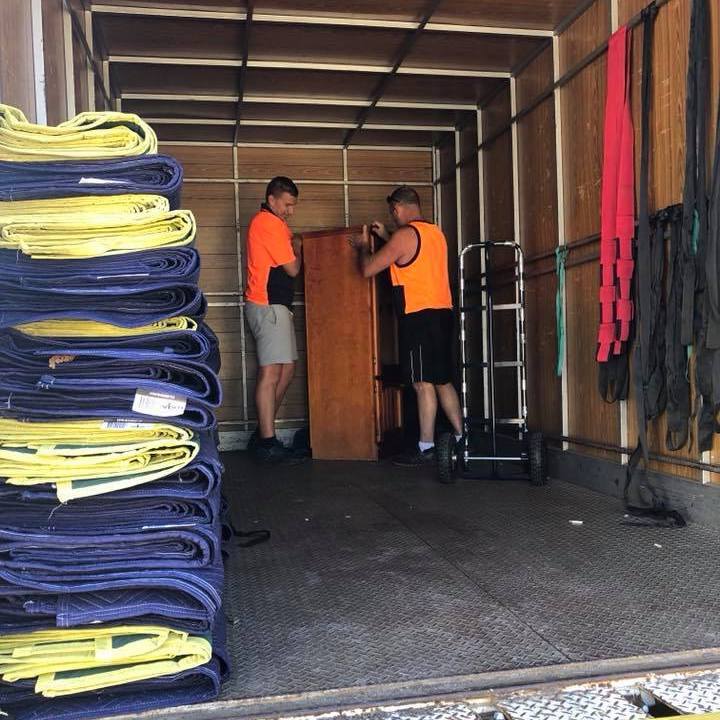 Furniture removalists in Forster-Tuncurry packing a wardrobe