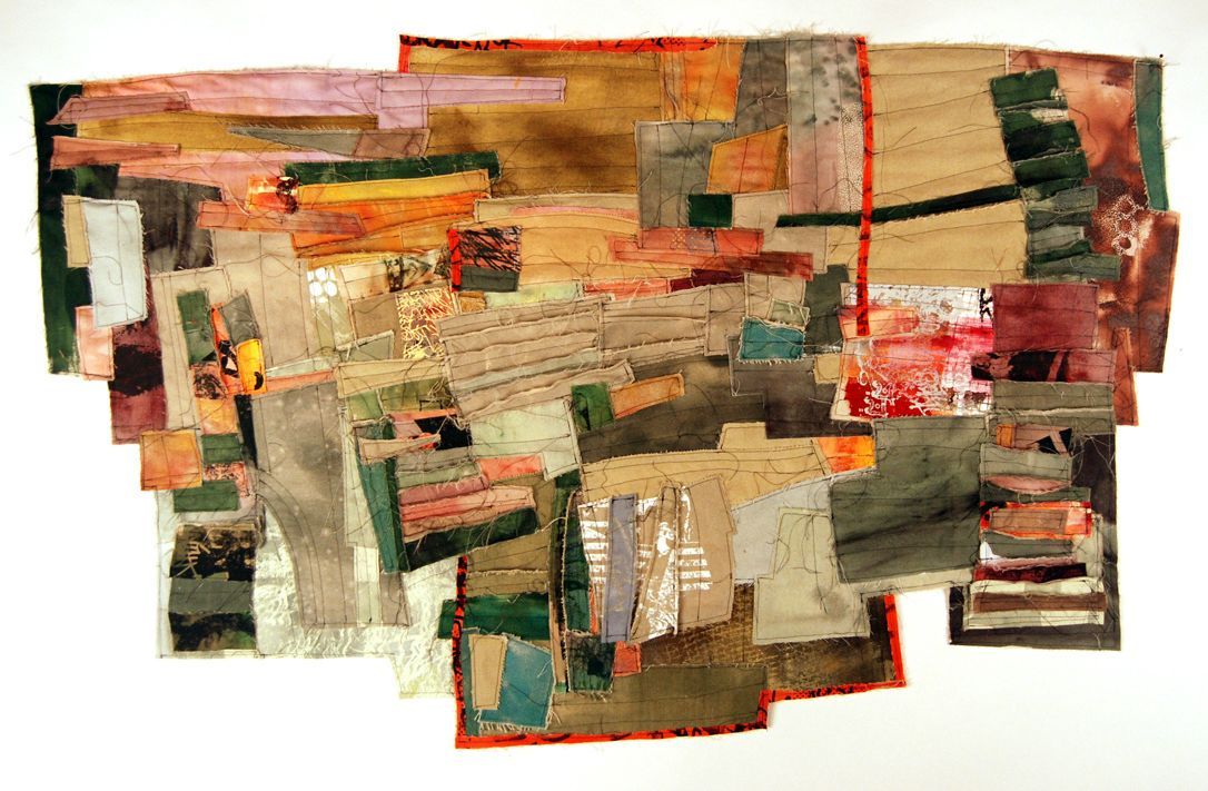 Abstract textile art with layered patches of color including green, brown, orange, and red.