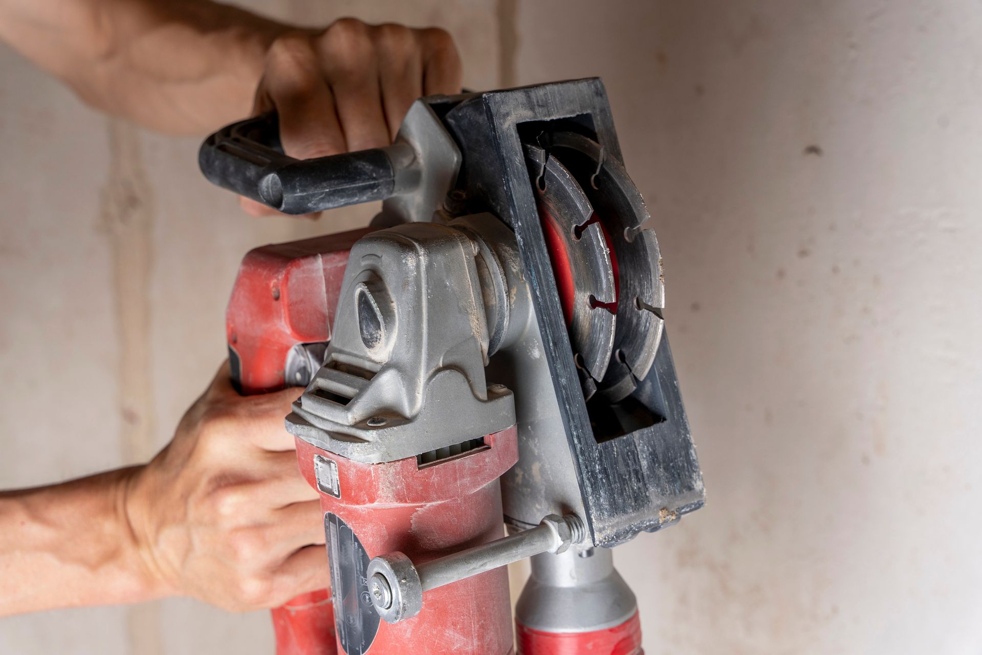 A person is holding a circular saw in their hands.