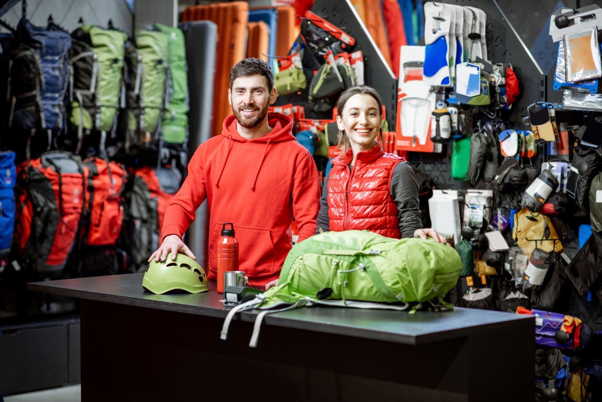 a man and a woman standing behind a counter in a store