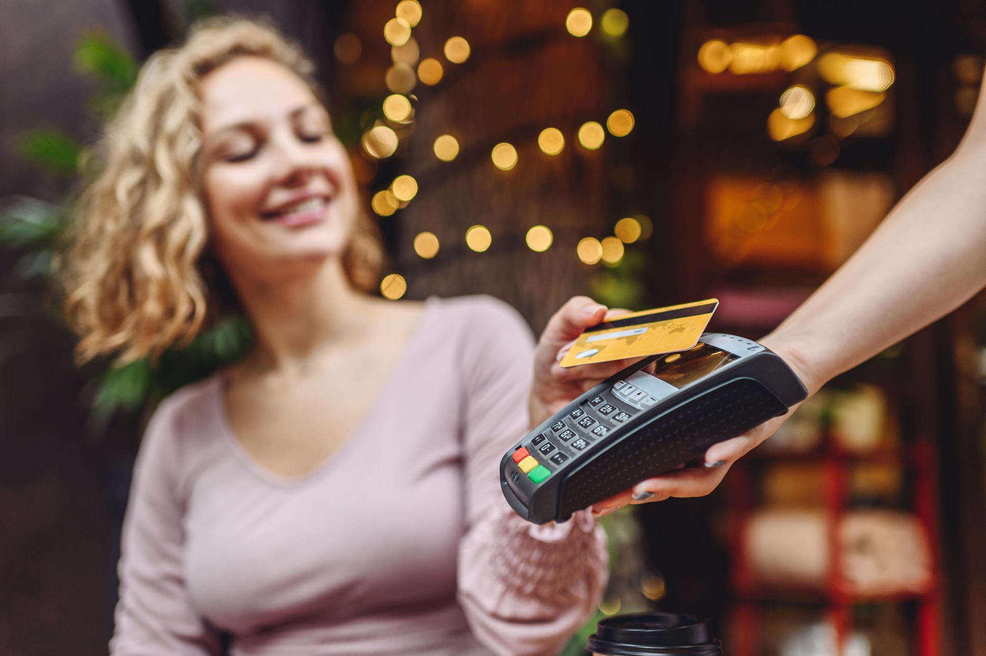 a woman is using a credit card to pay for something
