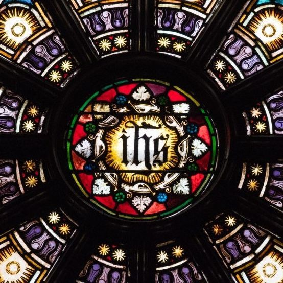 A stained glass window with the letters ihs on it