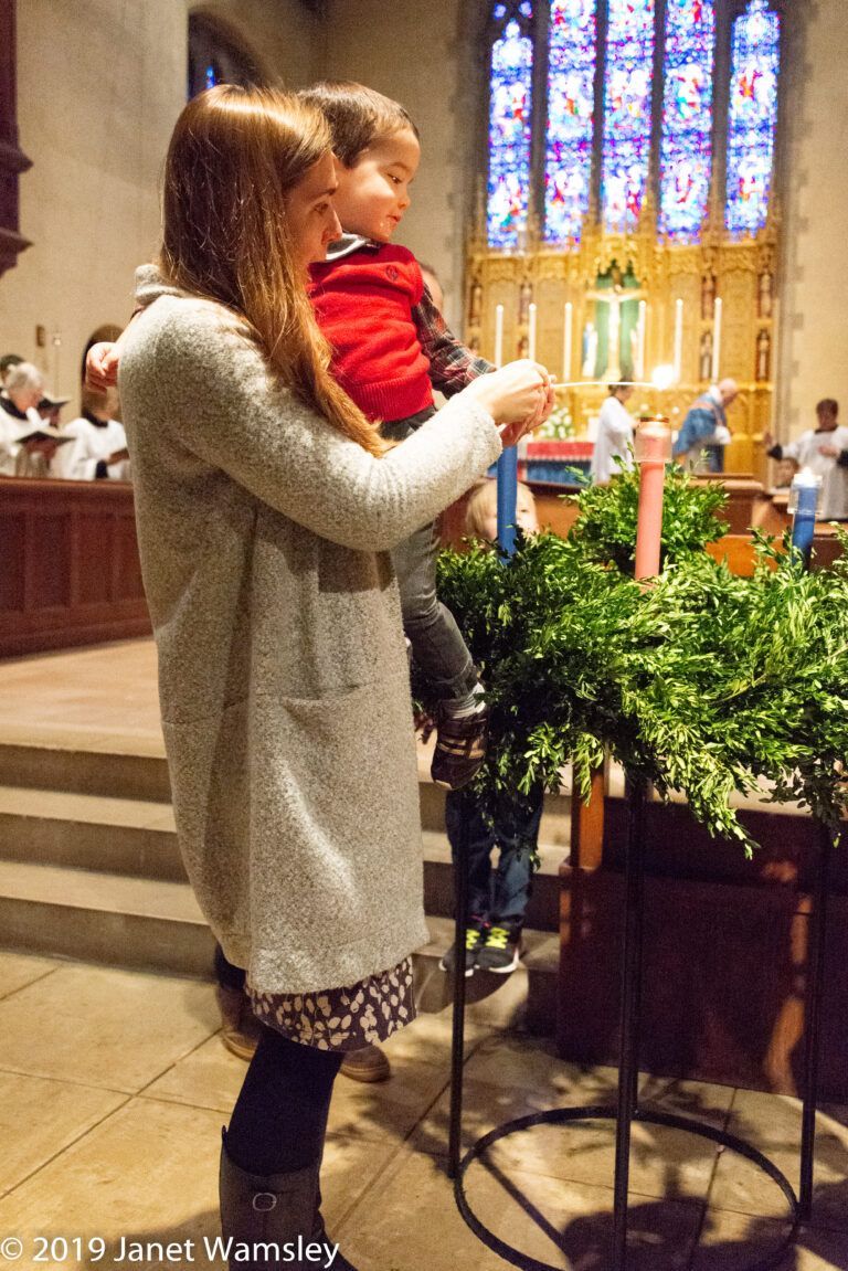 A woman is holding a child in her arms in a church.