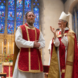 A religious procession with altar servers carrying candles and incense at an altar, in church.